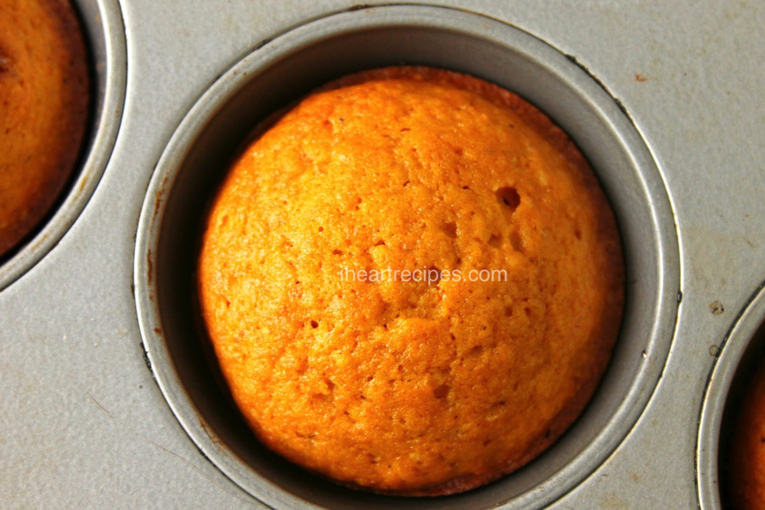 An overhead shot of a perfect-baked homemade sweet potato muffin in a muffin tin. 