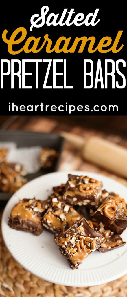 Salted Caramel Pretzel Bars piled on a round white plate on top of a rattan placemat. 