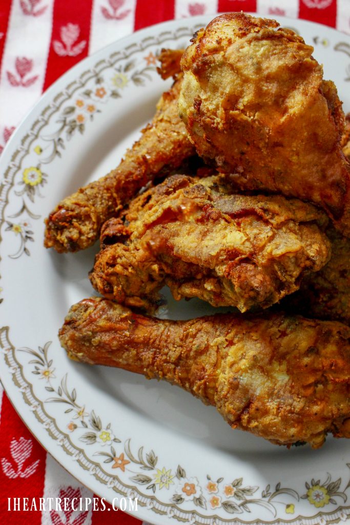 Crispy golden brown southern fried chicken served on a floral platter.
