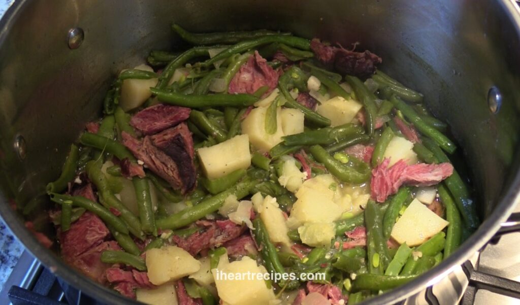 Cook the green beans in a pot with the potatoes, ground turkey, and add onions and garlic for the best flavor. 
