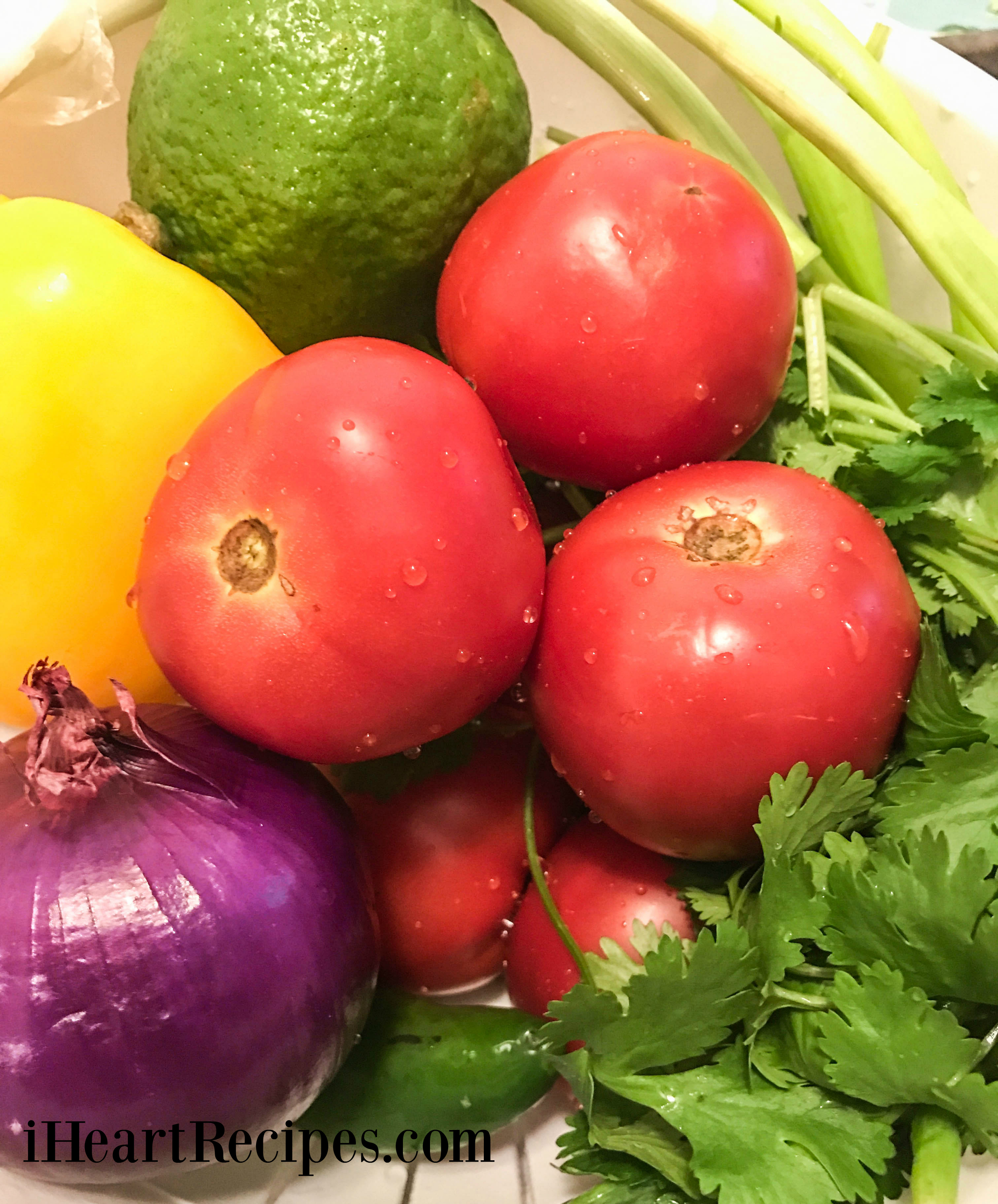 Bright and colorful vegetables in a white strainer ready to be made into a tasty pico de gallo!