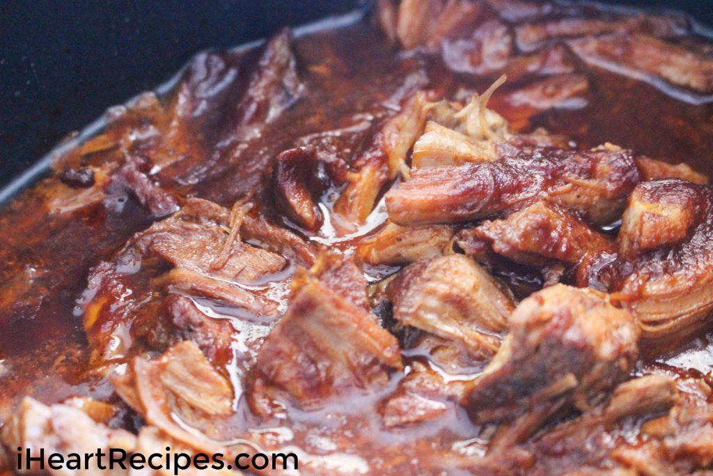 Tender and savory slow cooked BBQ pulled pork simmering in a slow cooker. This recipe is fool-proof, easy and so tasty!