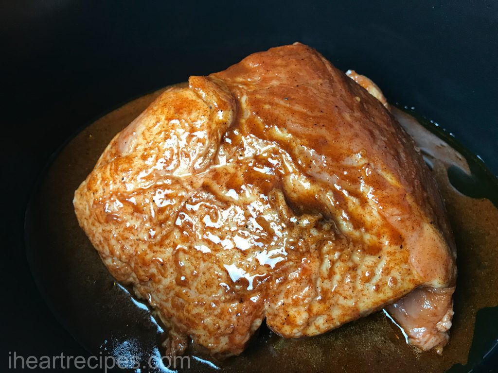 A prepared, perfectly seasoned pork shoulder in the slow cooker. 