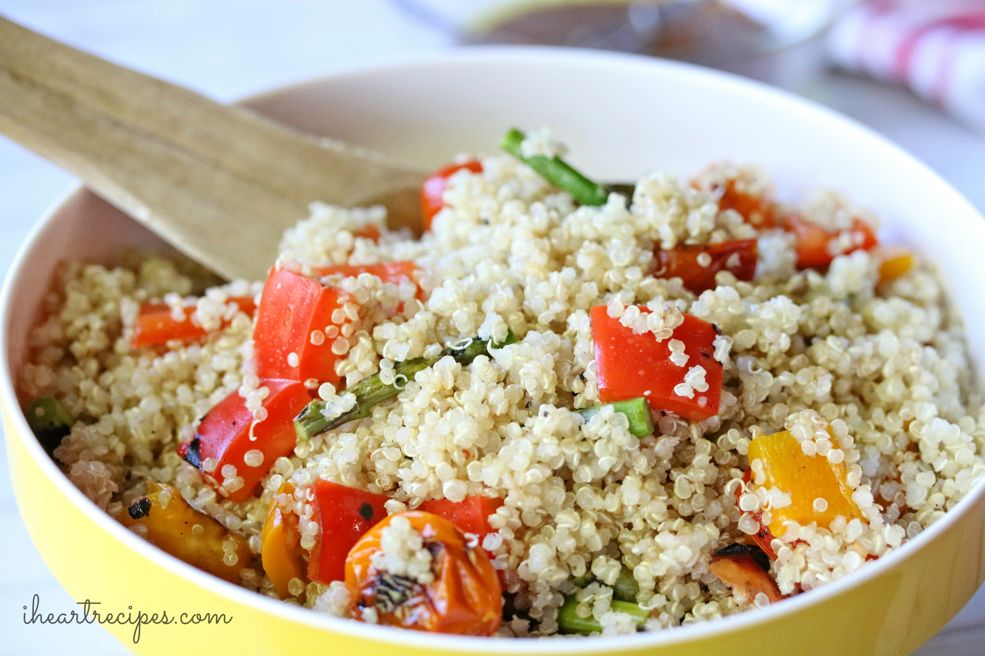 Flavorful Easy Quinoa Salad served in a yellow bowl. Quinoa is the star ingredient, but these grilled veggies add a ton of savory flavor!