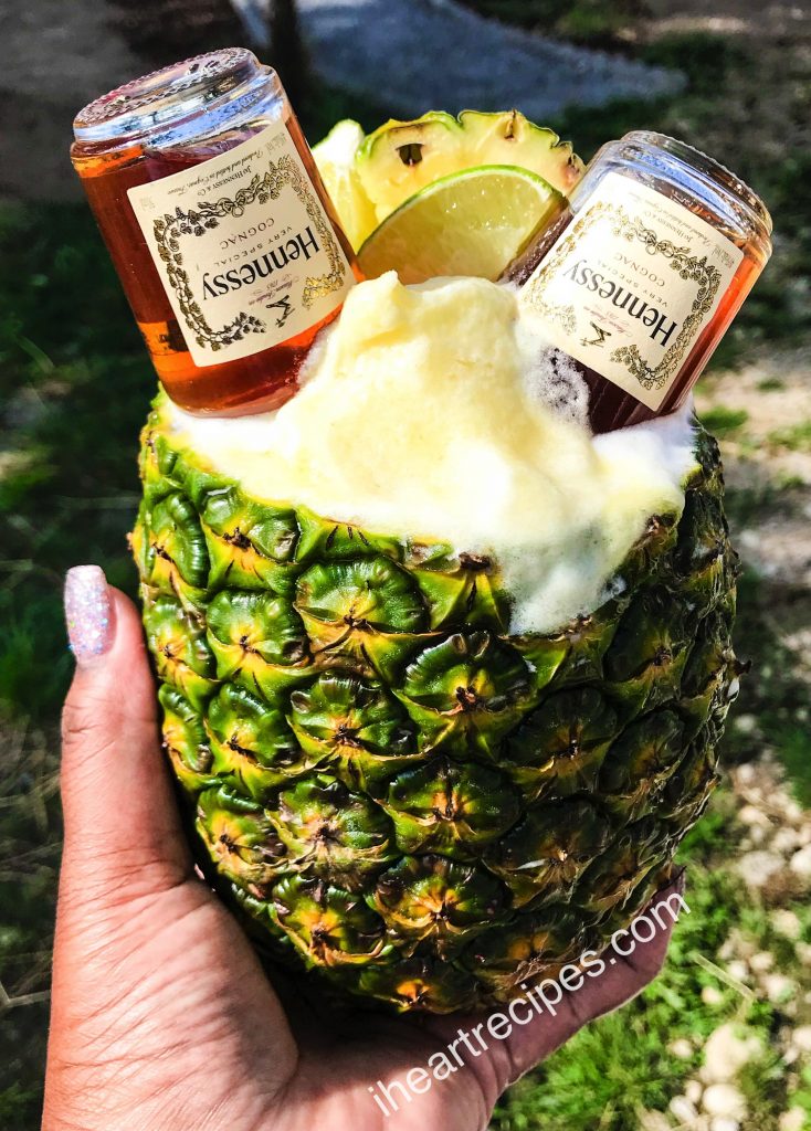 Serving this Hennessy margarita recipe in a hollowed out pineapple is so fun!