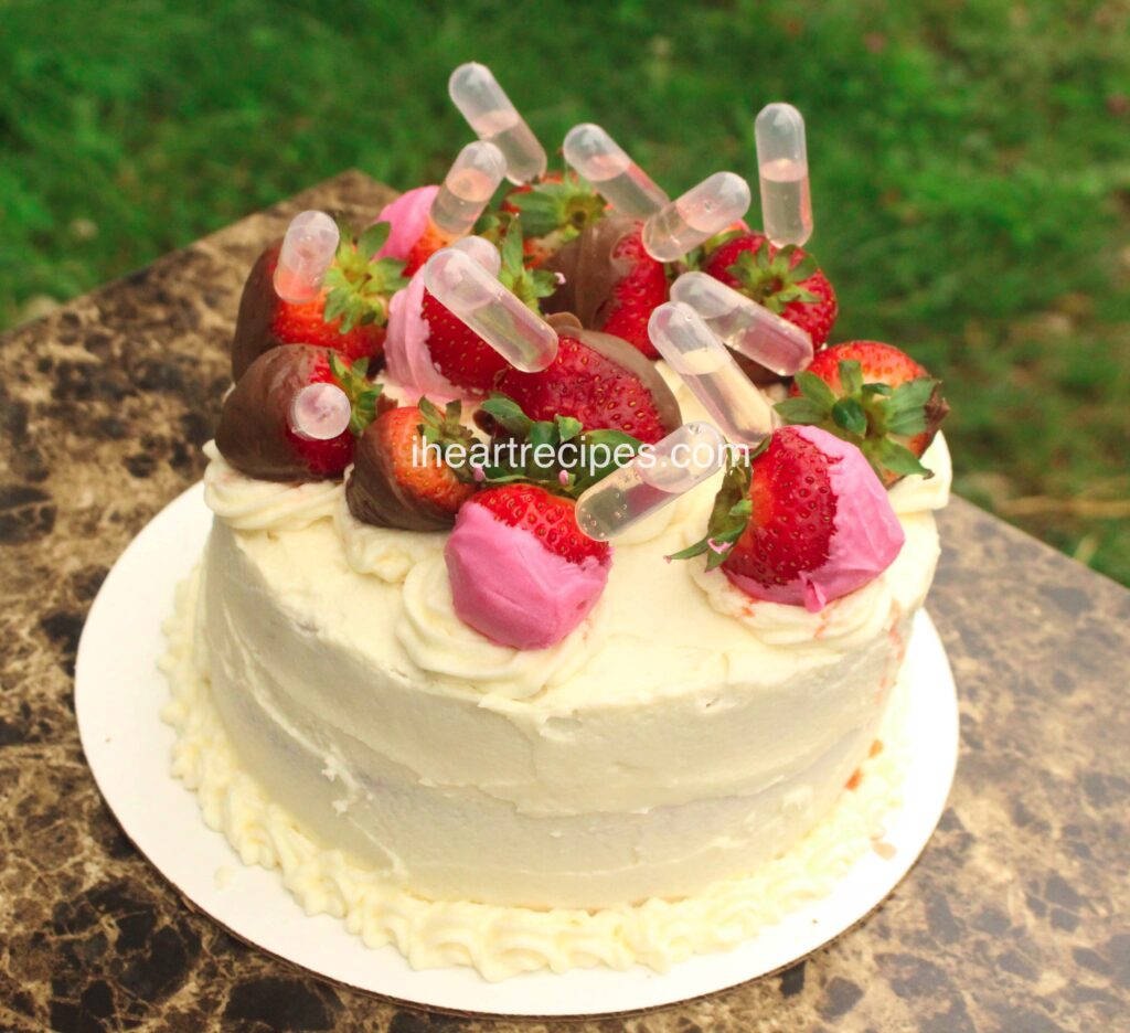 This pink moscato cake is infused with sweet moscato wine and topped with chocolate covered strawberries.