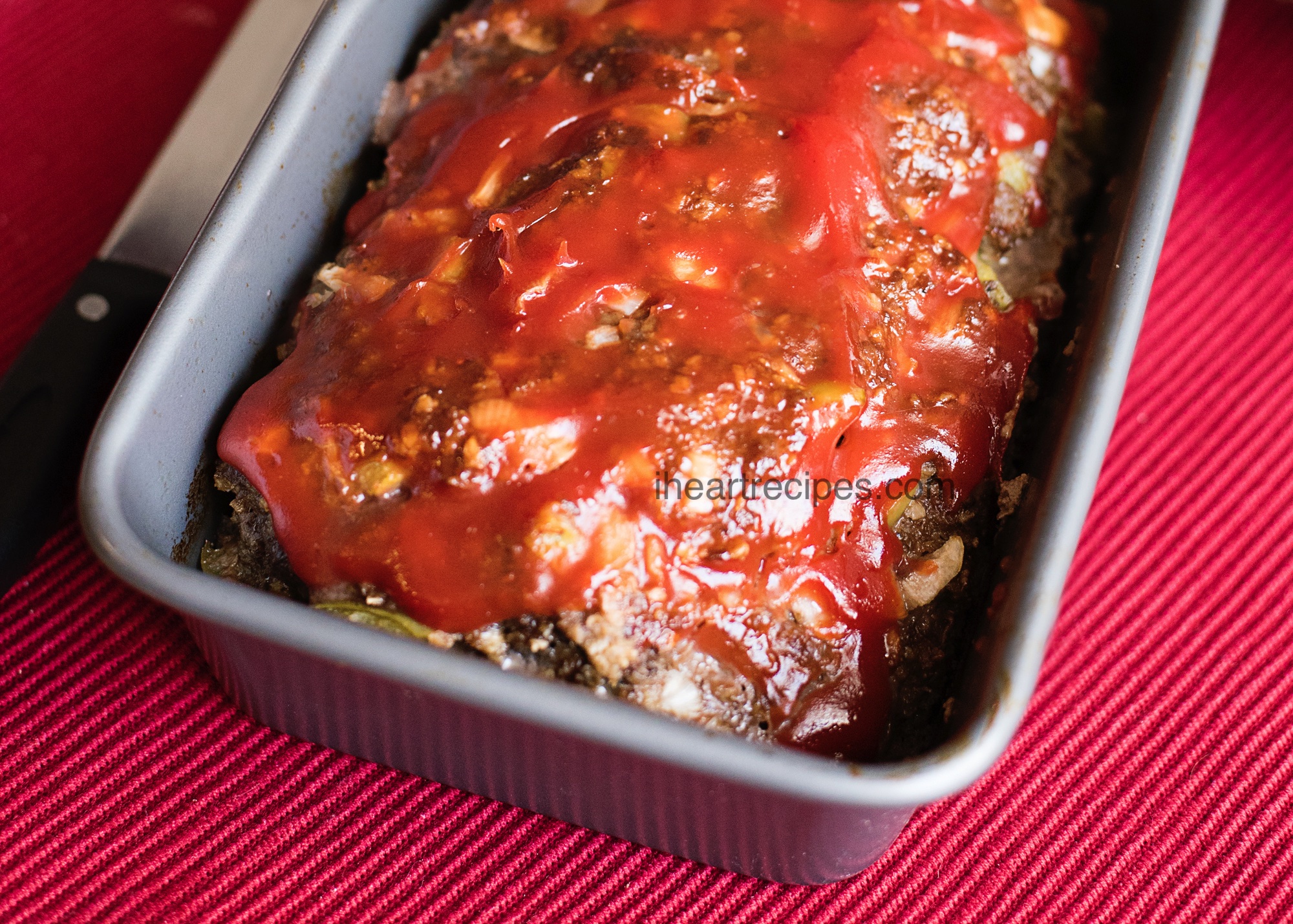 Moist and tender classic meatloaf in a piping hot pan ready for family dinner!