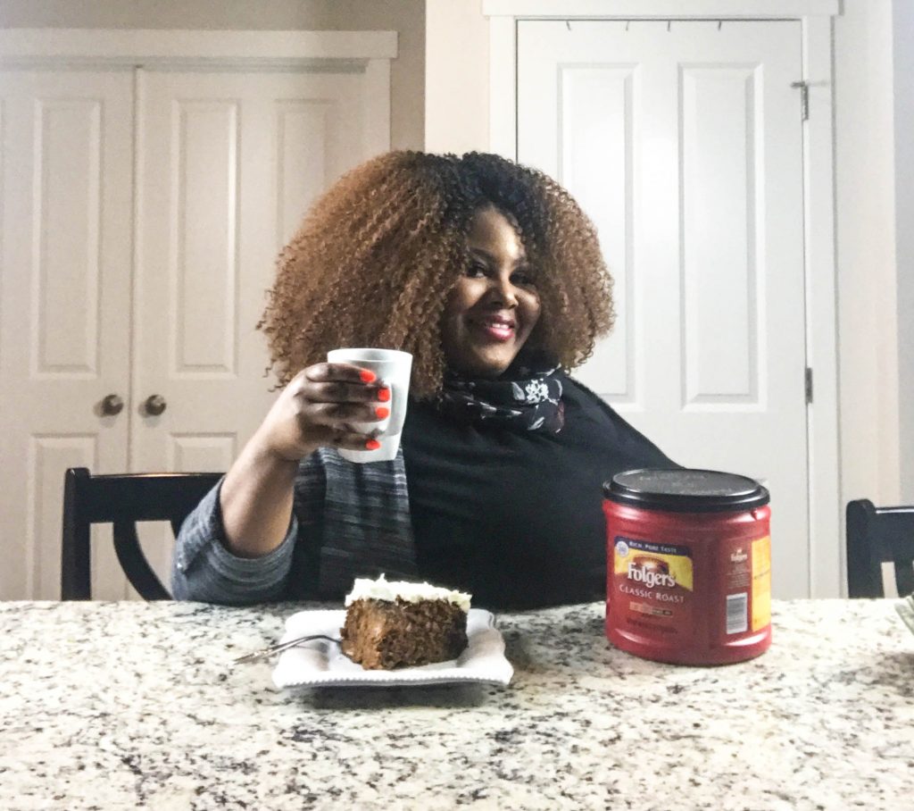 Rosie enjoying a slice of classic homemade hummingbird cake with a cup of Folgers coffee in her hand. 