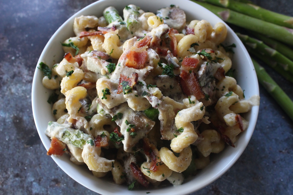 This Creamy Cavatappi pasta recipe is packed with bacon, mushrooms, and asparagus in a creamy gouda and garlic sauce