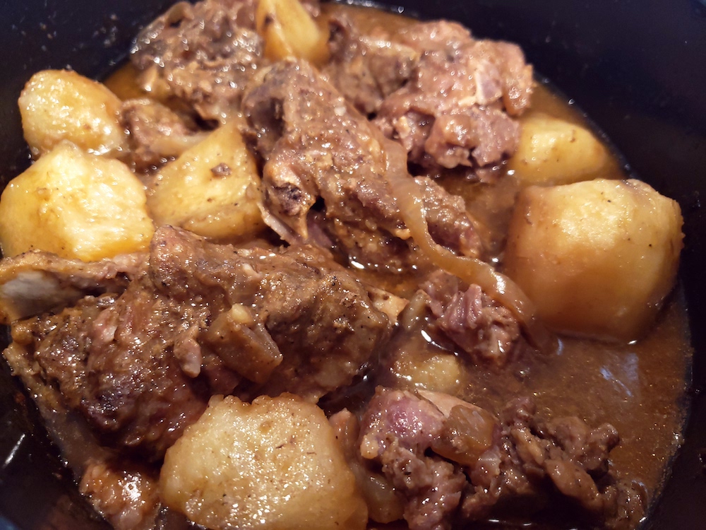 Neck bones and potatoes are slow cooked to fork-tender perfection, in a delicious gravy