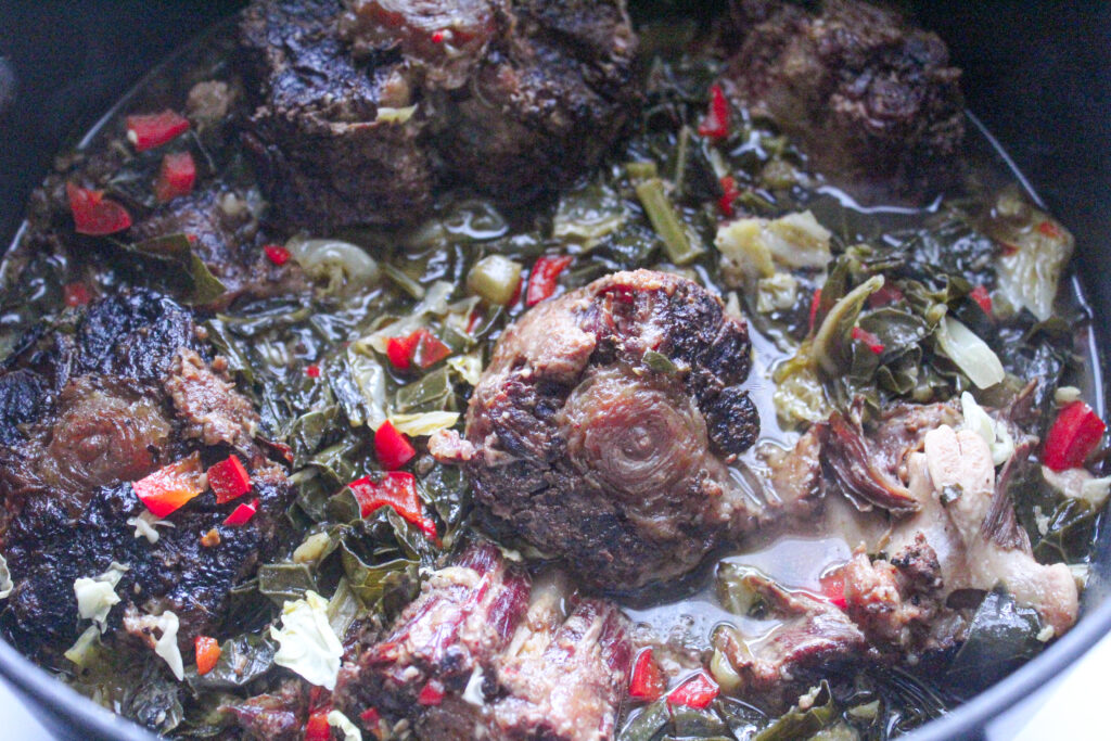 Tender smoked oxtails cooked over a bed of delicious collard greens