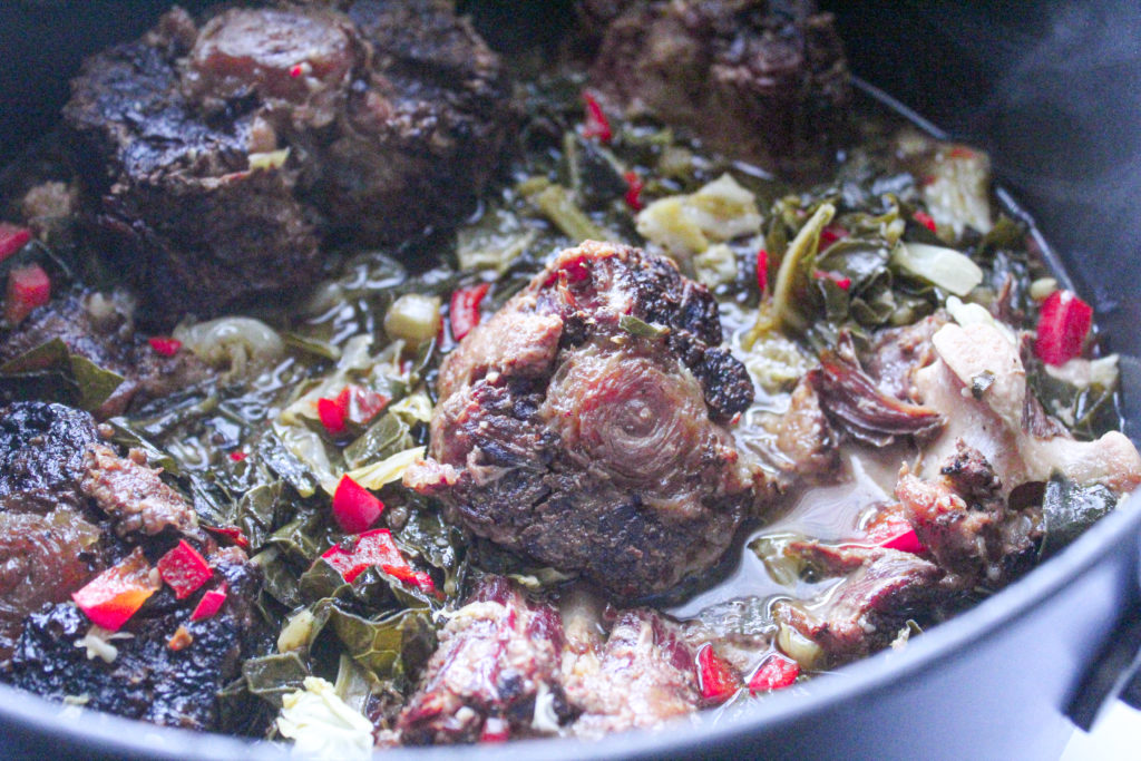 Tender smoked oxtails are cooked with classic collard greens for a delicious southern dish