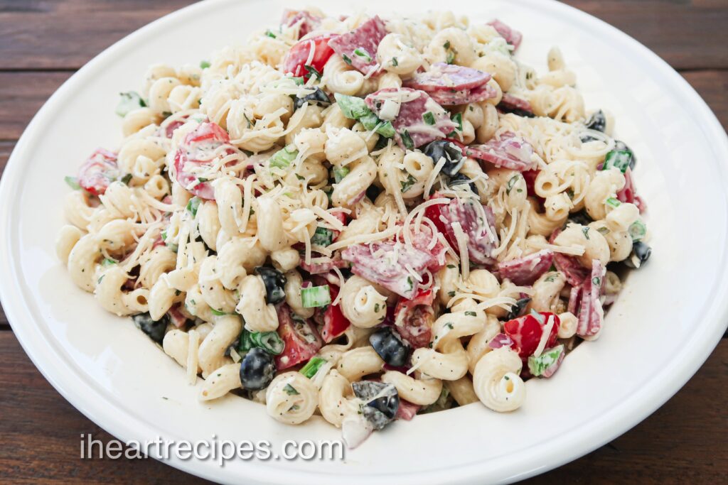 Italian style pasta salad is packed with hucks of salami, tomatoes, olives, and coated in a delicious Italian dressing.