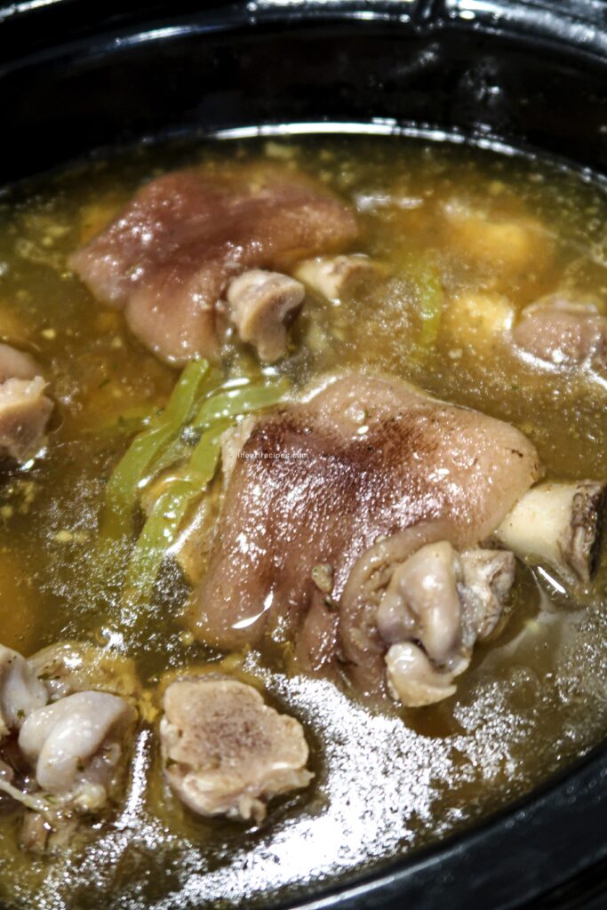 A closer look at the tender pigs feel slowly simmering in slow cooker broth.