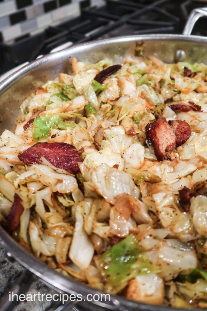 A skillet full of pan-fried cabbage, bacon, and onions - a deliciously flavorful Southern side dish.