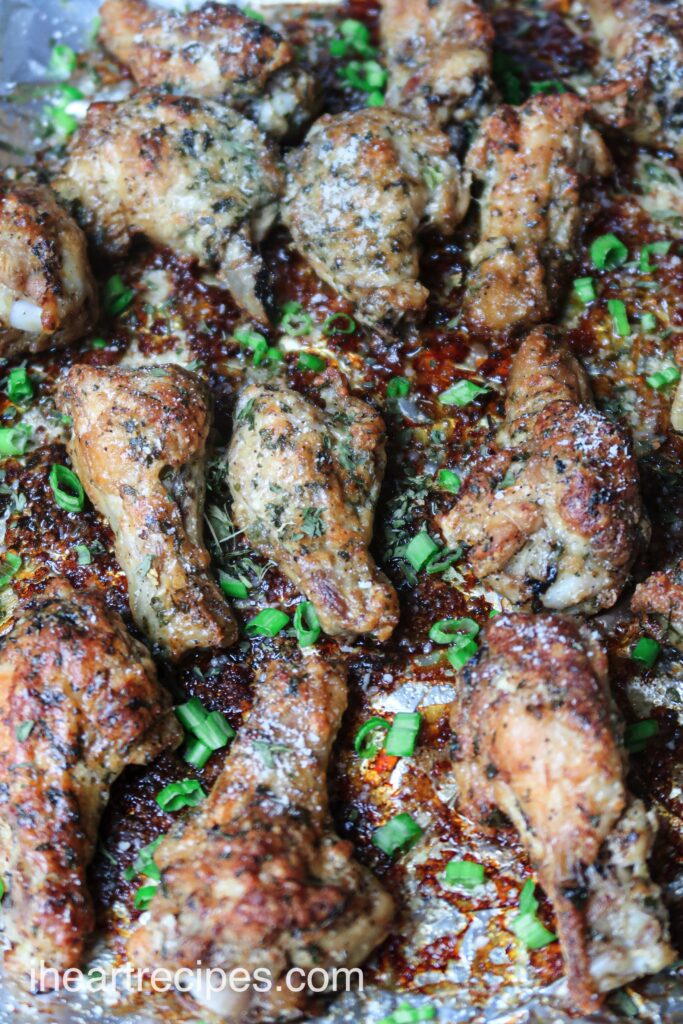 A close up look at my tender, juicy baked garlic parmesan chicken wings, garnished with chopped green onions.