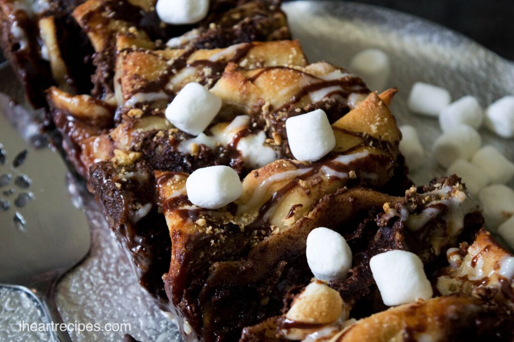 Gooey chocolate s'mores pull apart bread topped with mini marshmallows and drizzled with sweet icing.