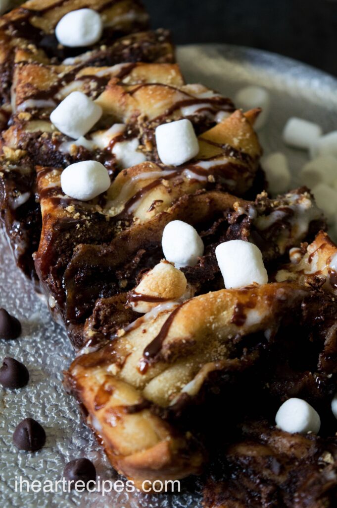 Gooey, chocolately s'mores pull apart bread made with pizza dough, tons of chocolate hazelnut spread and marshmallows, and sweet chocolate and vanilla icing drizzle.