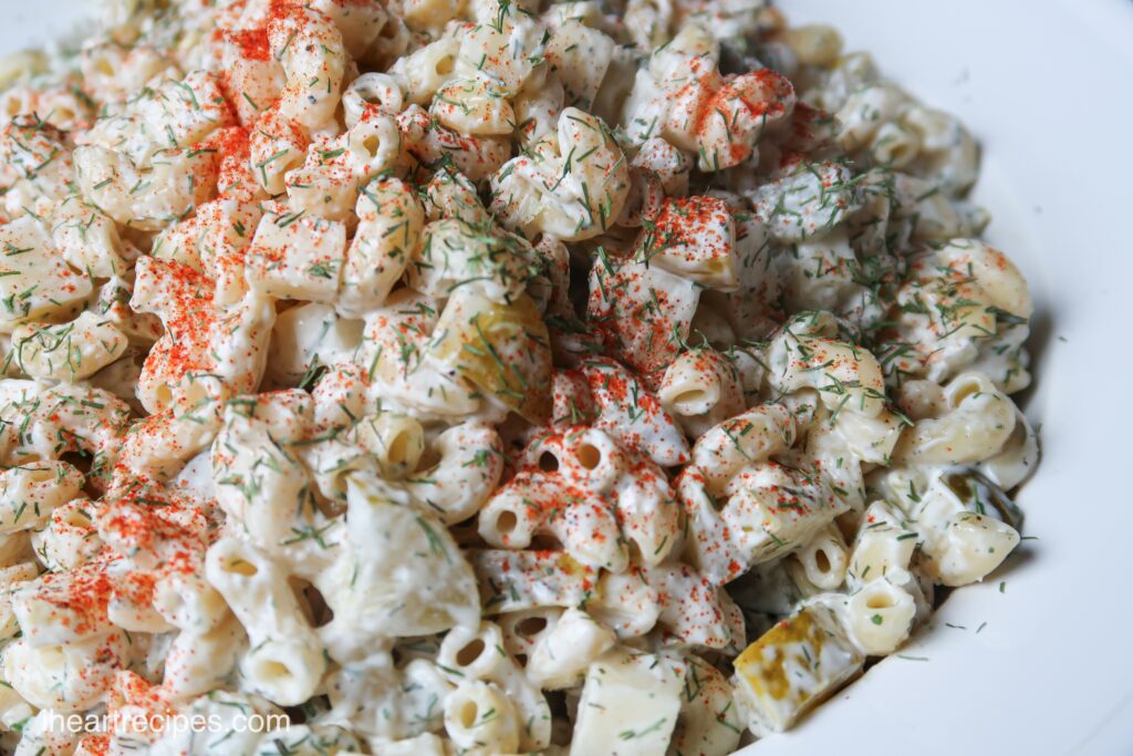 A creamy pasta salad loaded with dill, cheese, and spices, perfect for a summer party.