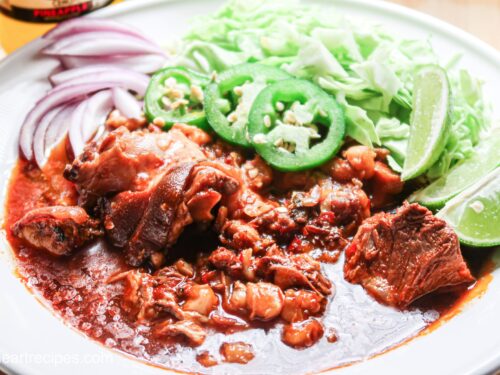 Slow cooker pork pozole with flavorful toppings.