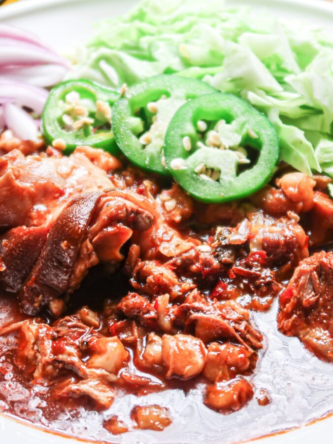 Slow cooker pork pozole with flavorful toppings.