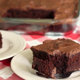 A slice of sour cream chocolate cake with a sweet chocolate frosting.