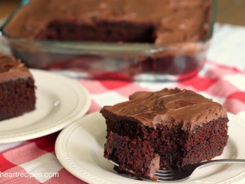 A slice of sour cream chocolate cake with a sweet chocolate frosting.