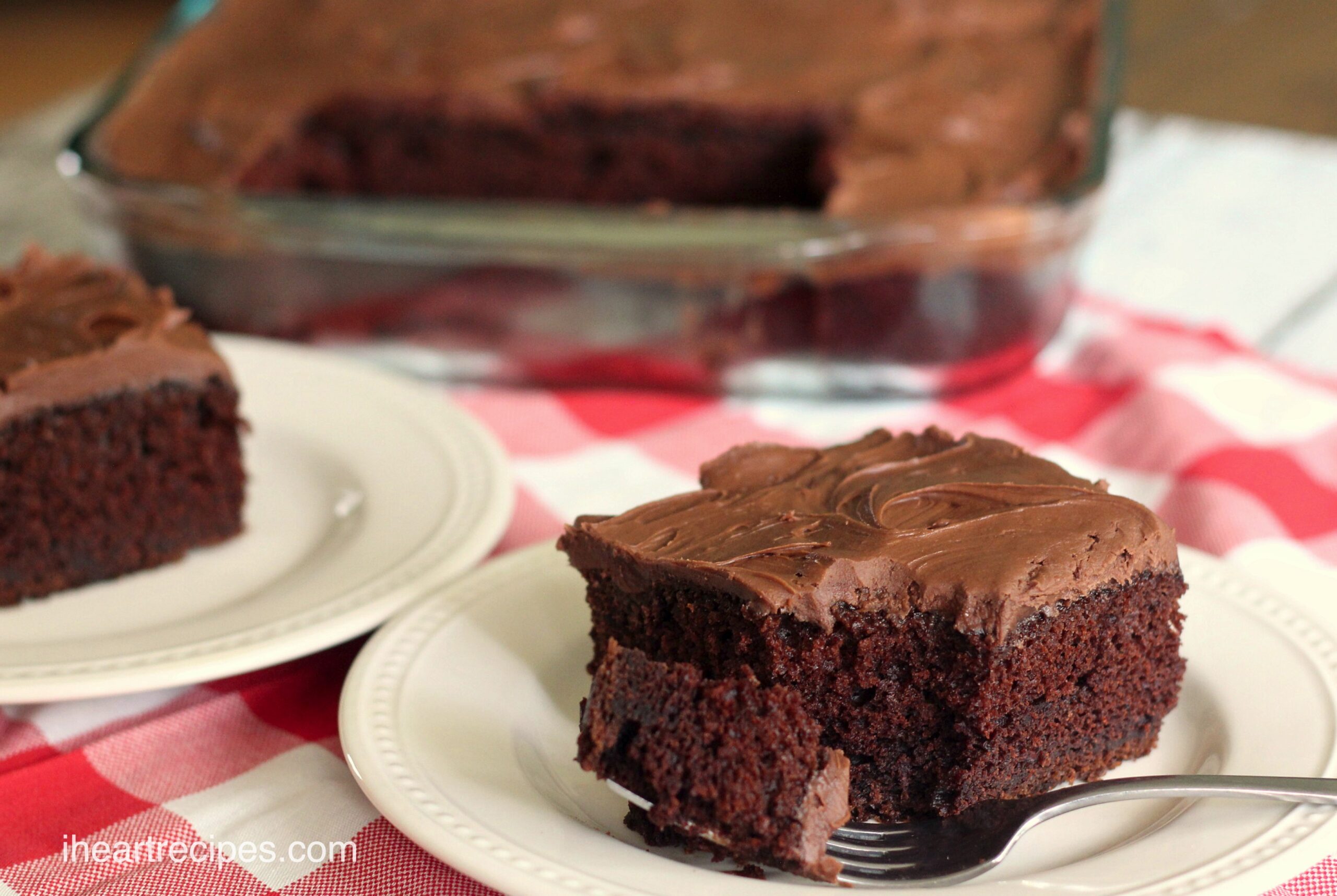 A slice of sour cream chocolate cake with a sweet chocolate frosting.