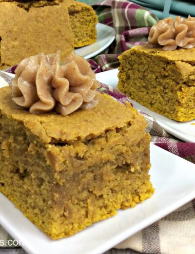 Two slices of pumpkin cornbread topped with a dollop of homemade spiced honey butter.