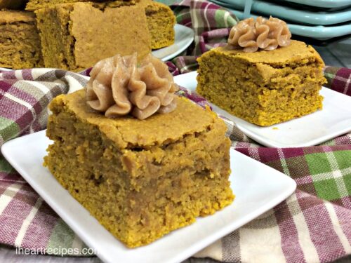 Two slices of pumpkin cornbread topped with a dollop of homemade spiced honey butter.