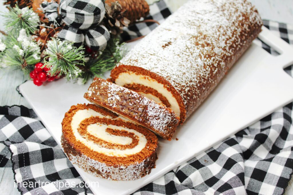 A homemade gingerbread Swiss roll filled with maple frosting and dusted with light powdered sugar.