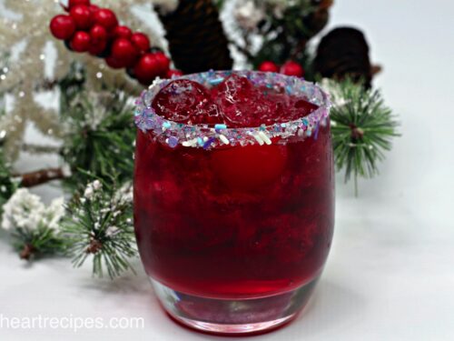 A Christmas cocktail made with gin, vodka, fruit punch, and Sprite.