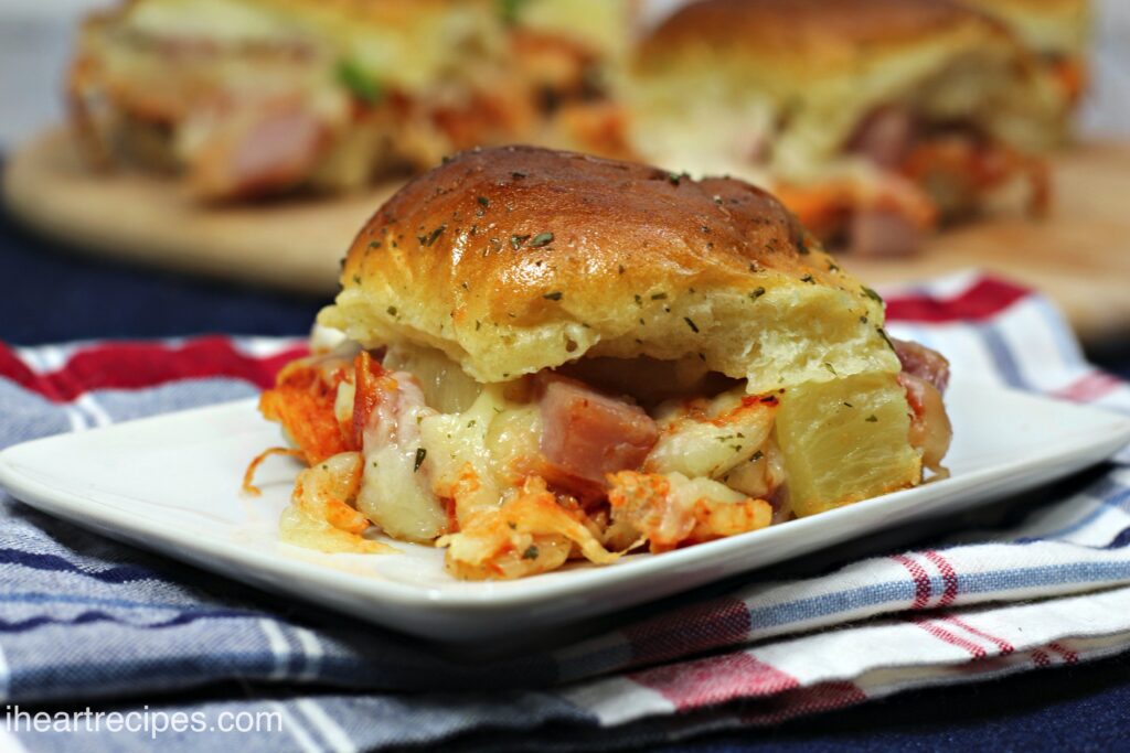 Pizza sliders made with Canadian bacon, pineapple, cheese, and pizza sauce.