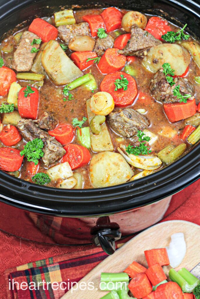 A close-up, overhead image of homemade beef stew, packed with carrots, celery, potatoes, and tender chunks of beef.