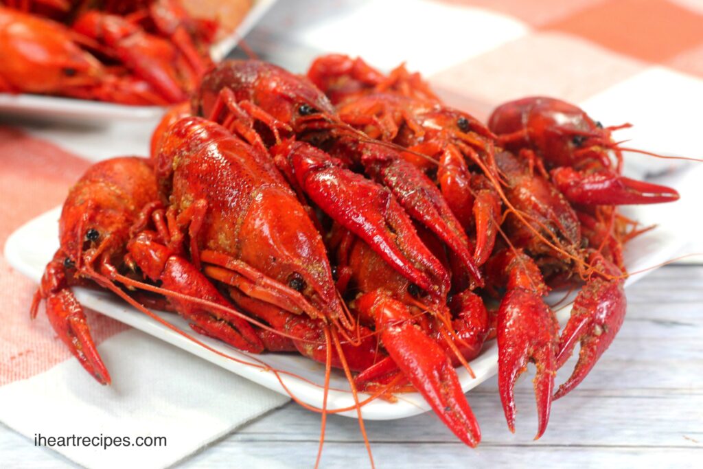 A small plate full of bright red cooked crawfish, served as part of an Instant Pot crawfish boil.