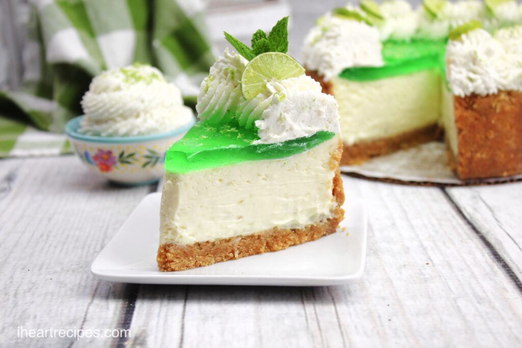 A single slice of key lime jello cheesecake served on a small dessert plate. 