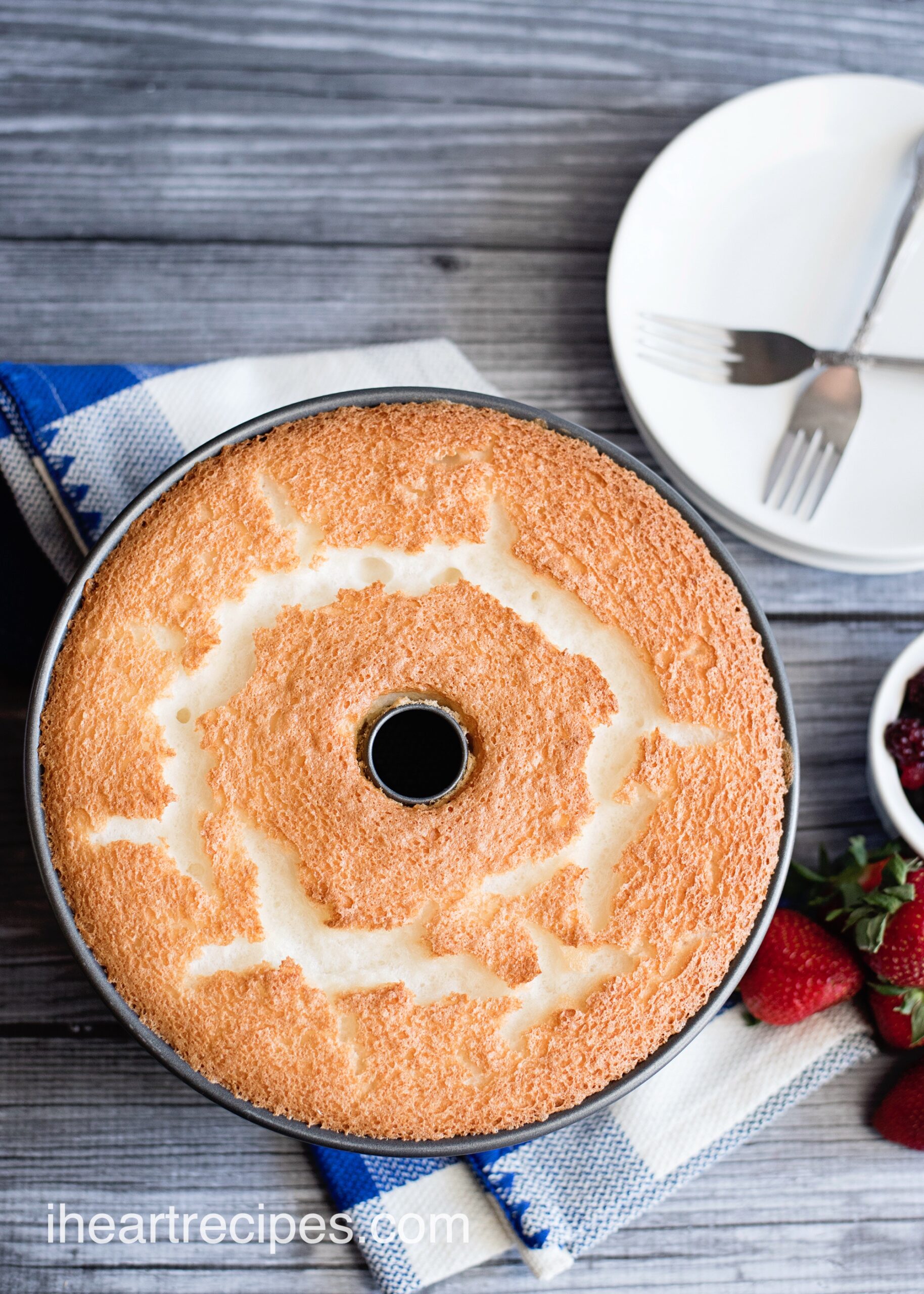An overhead image of a freshly baked homemade angel food cake, still in the round pan.