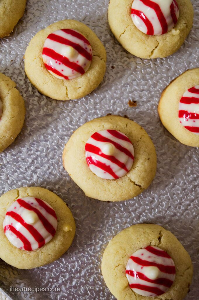 An overhead image of Candy Cane Thumbprint Cookies arranged on a silver platter. 