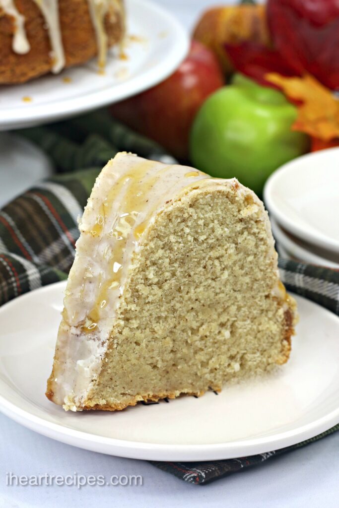 A close up image of a slice of bundt cake with caramel glaze drizzling down the side. 