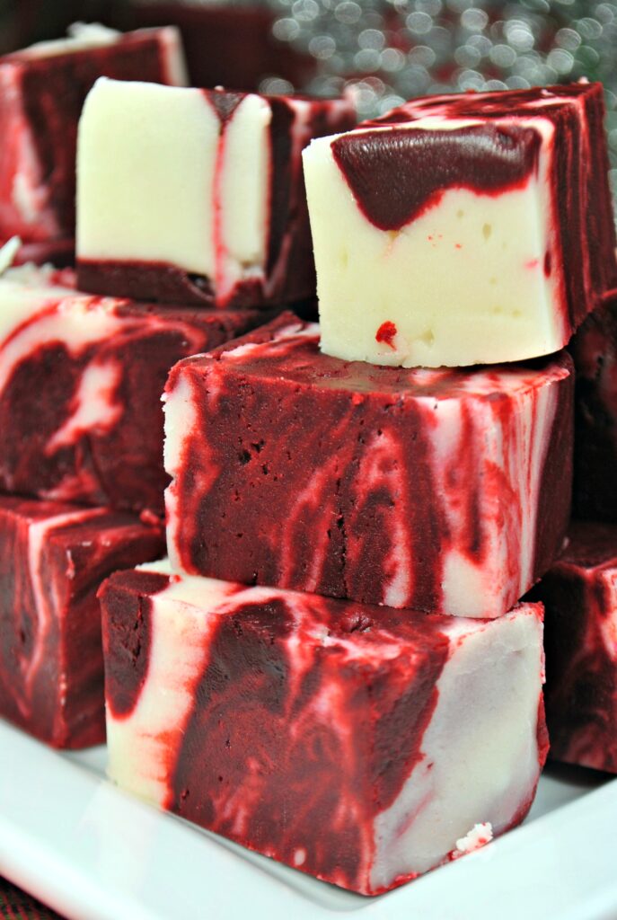 A close up of cubes of red velvet swirled with white chocolate.