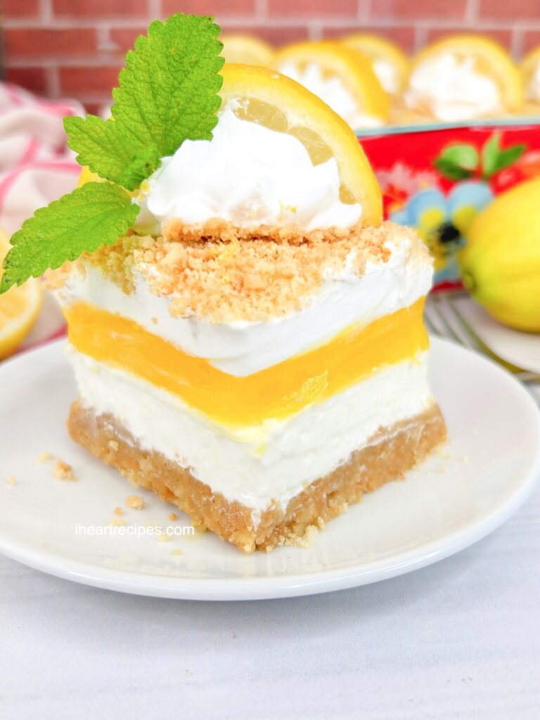 A close up of Layered Lemon Dream Dessert which shows the varying textures and colors of this sweet cake. 