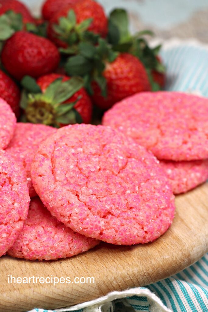 A close up image of pink sugar cookies highlighting cracked sugary tops. 