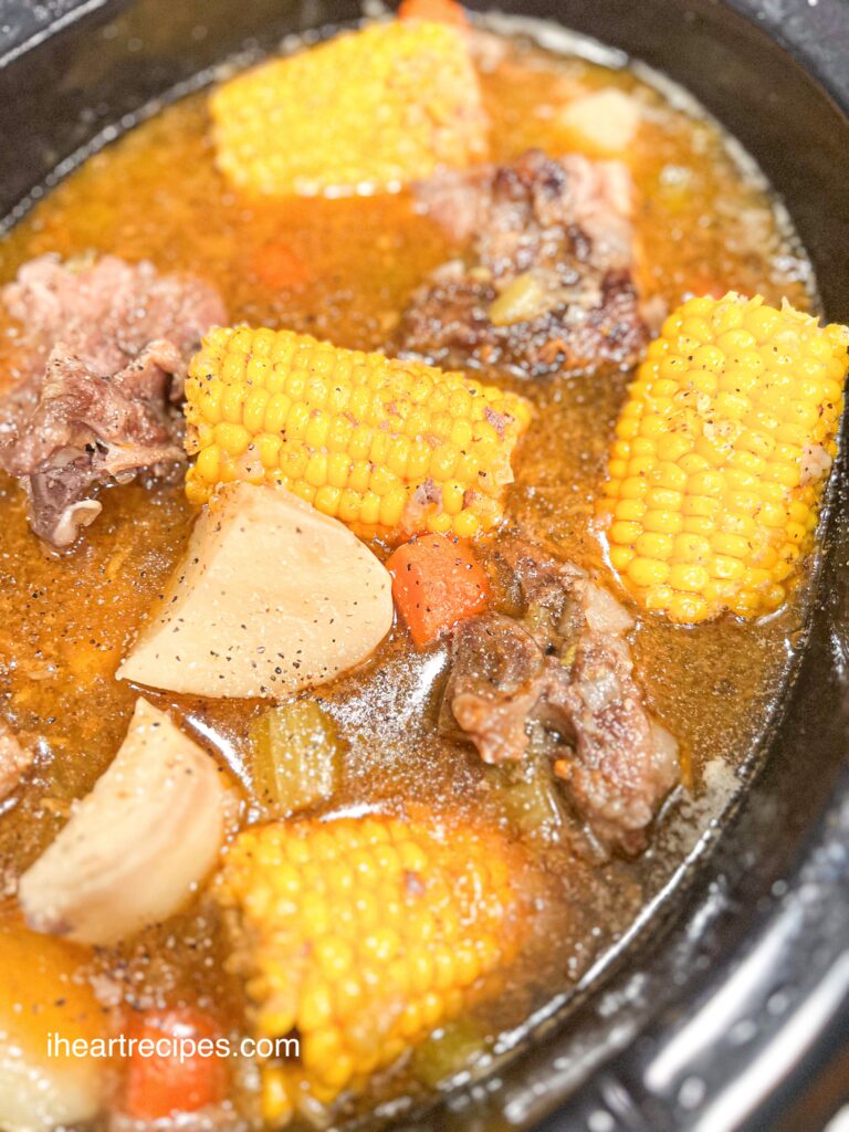 Tender pork, golden corn cobs, and veggies simmering in a golden broth. 