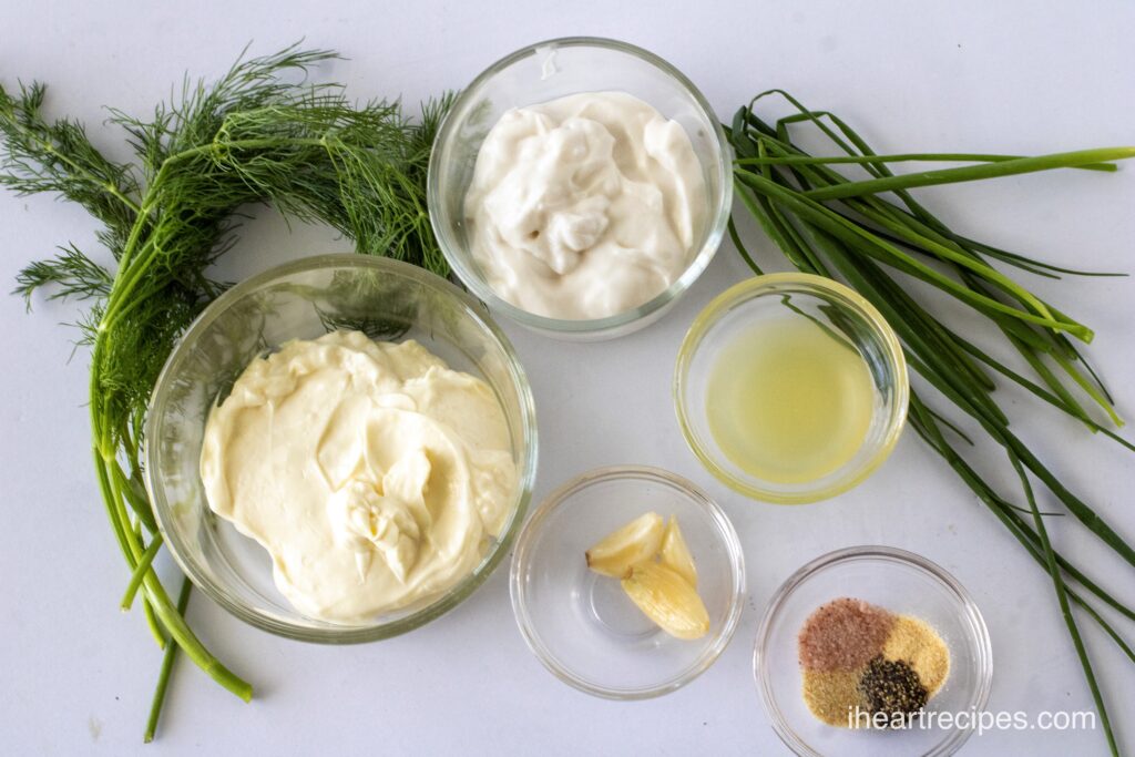 Small glass bowls of different ingredients for ranch dressing. 