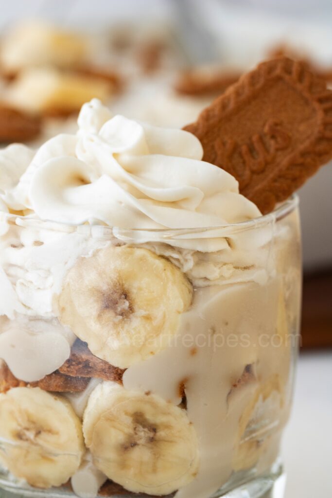 Vegan Banana Pudding in a cup with whipped topping and cookies.