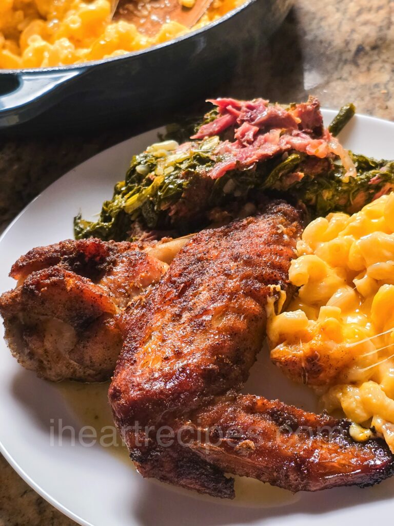 Roast Turkey Wings served with macaroni and cheese, and turnip greens.