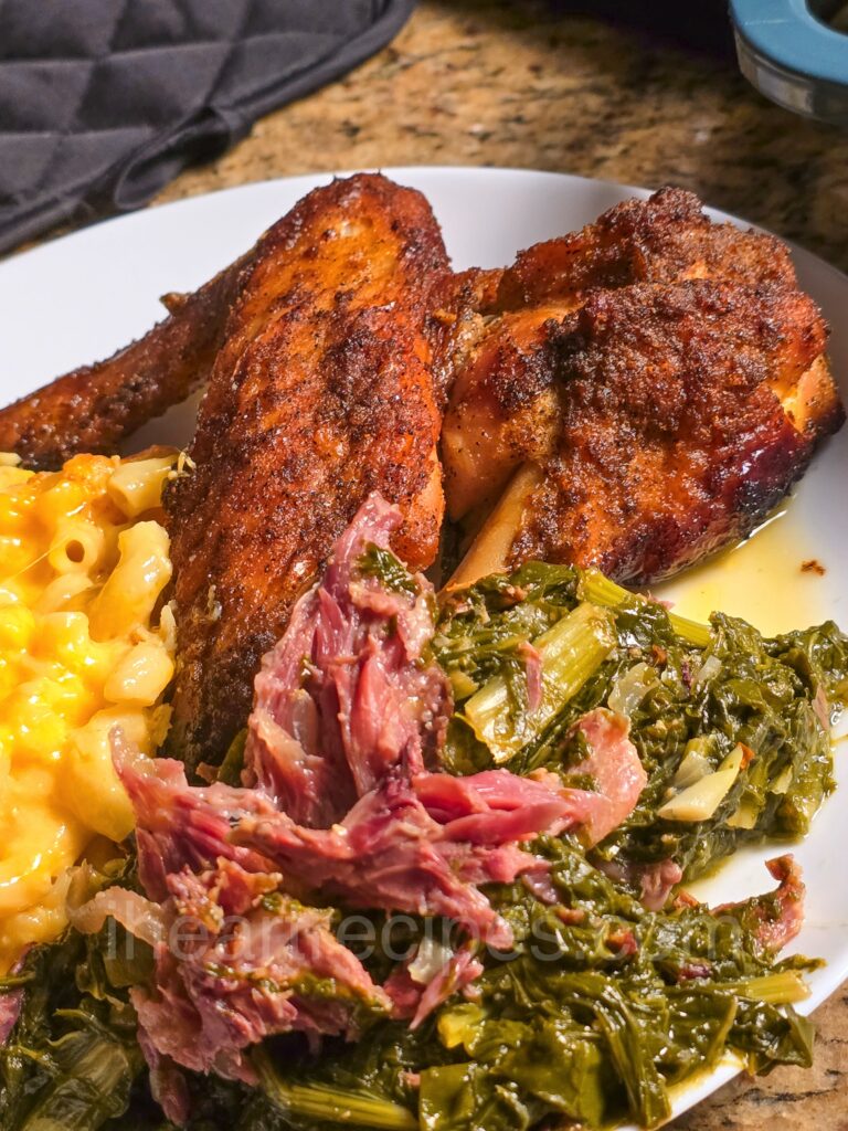 Golden turkey wings served with macaroni and cheese, and southern greens.