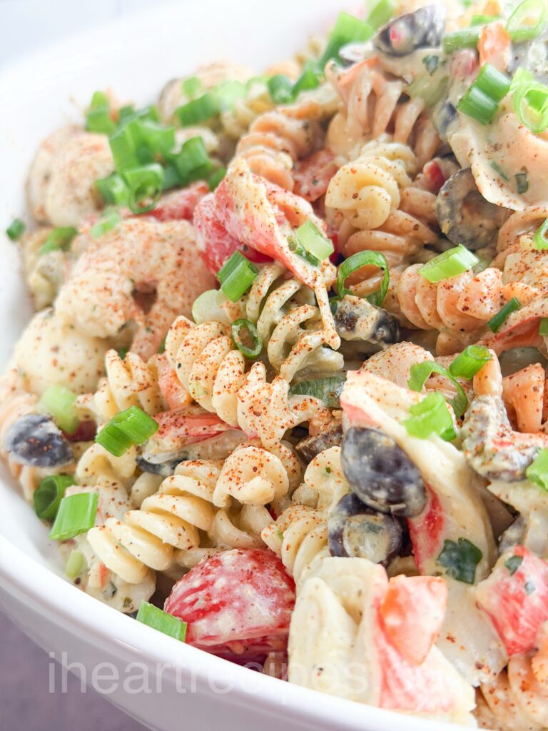 seafood pasta salad in a white bowl.